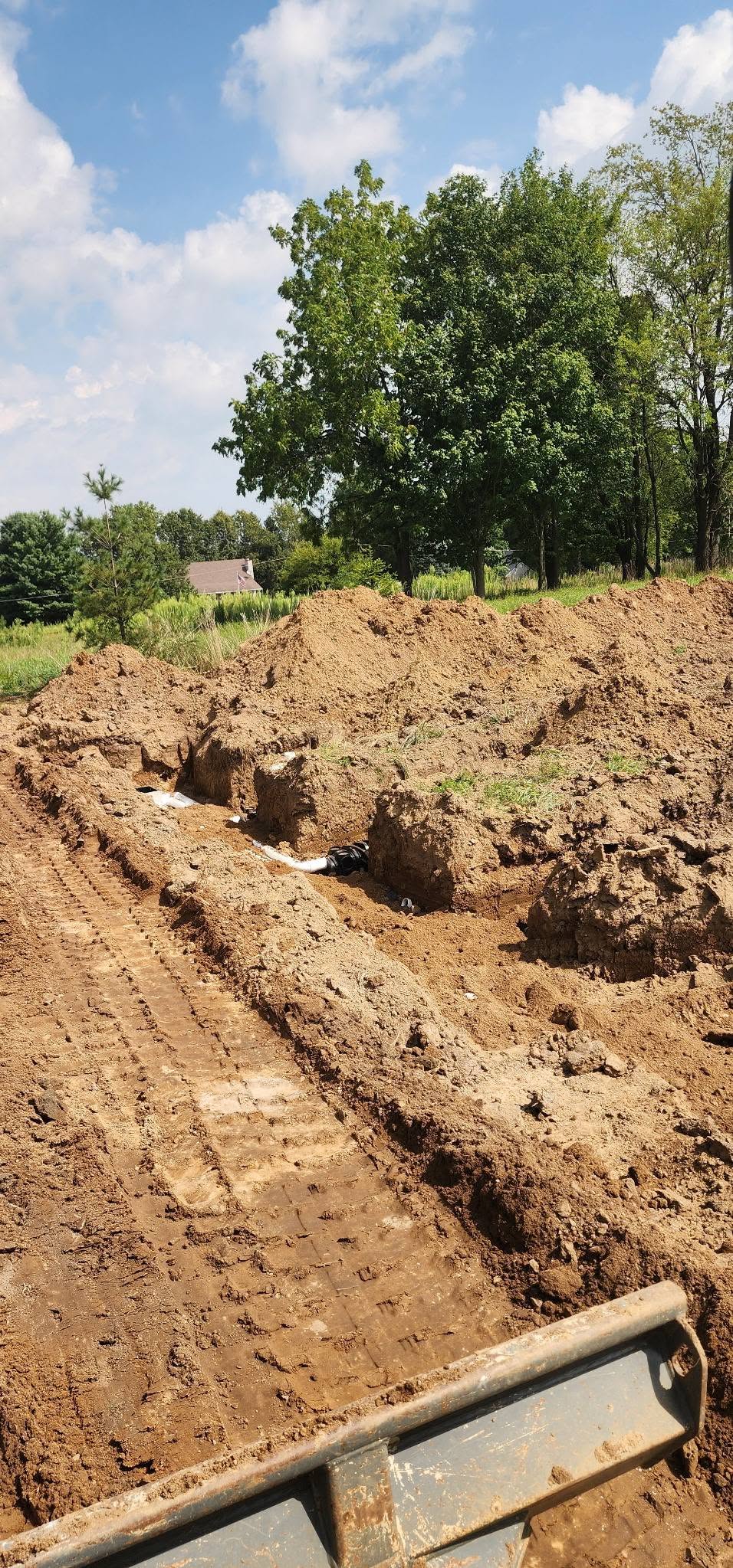 Excavated septic site with PVC piping and distribution components